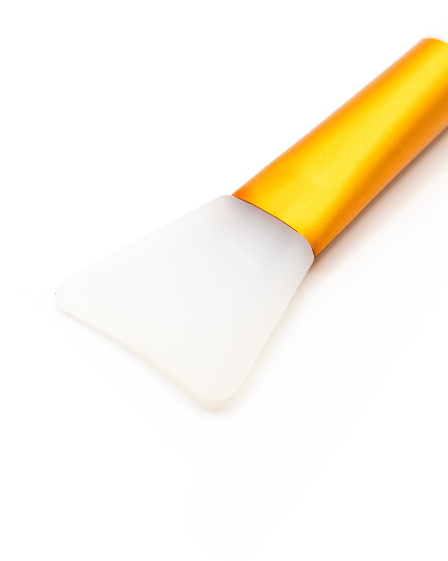 White makeup brush with a yellow handle on a white background