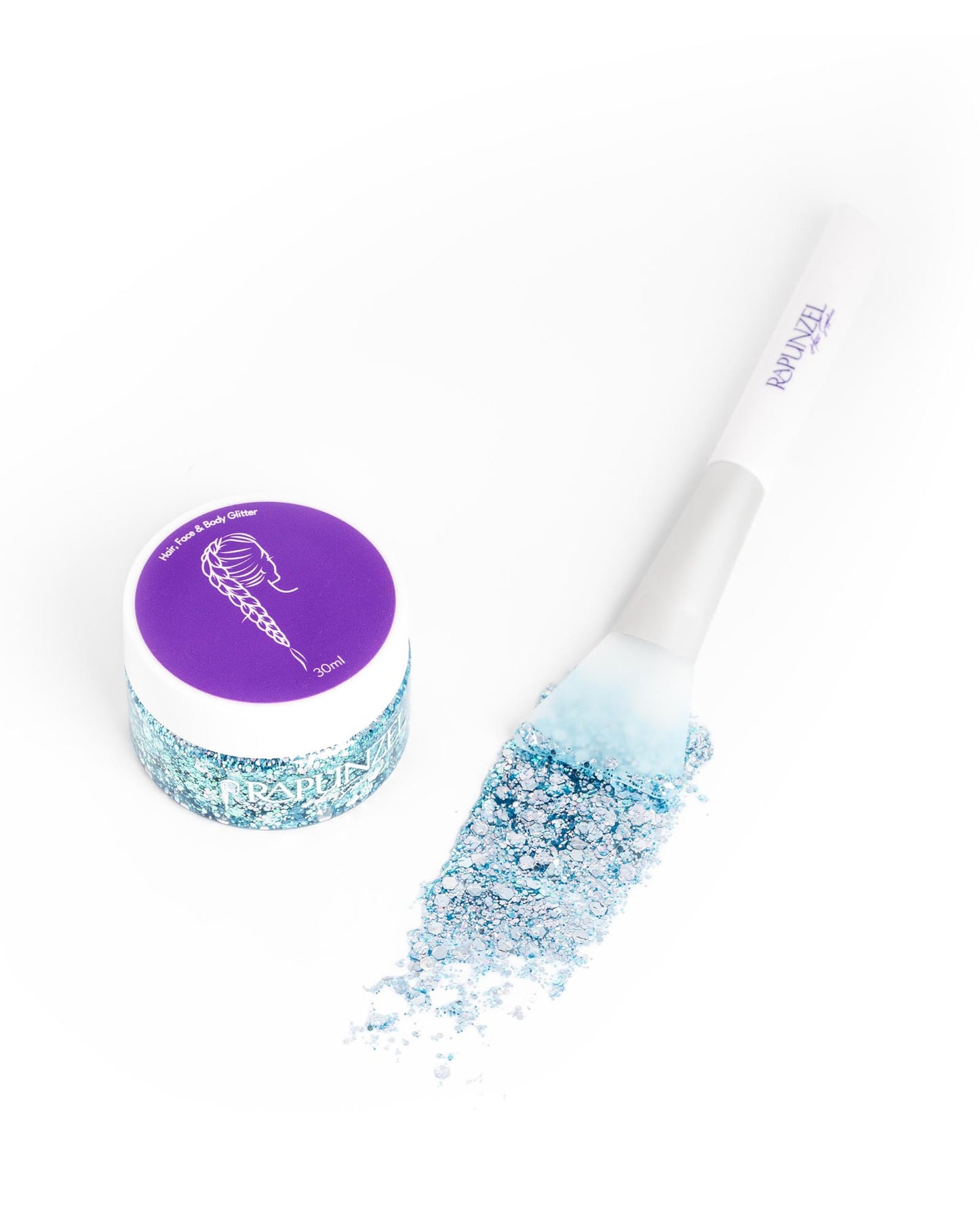 Cosmetic brush with glittery blue powder and glitter container on a white background